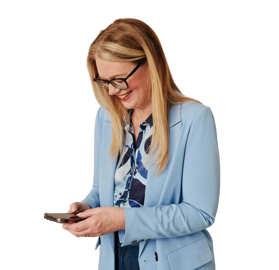 A parent smiling at her phone